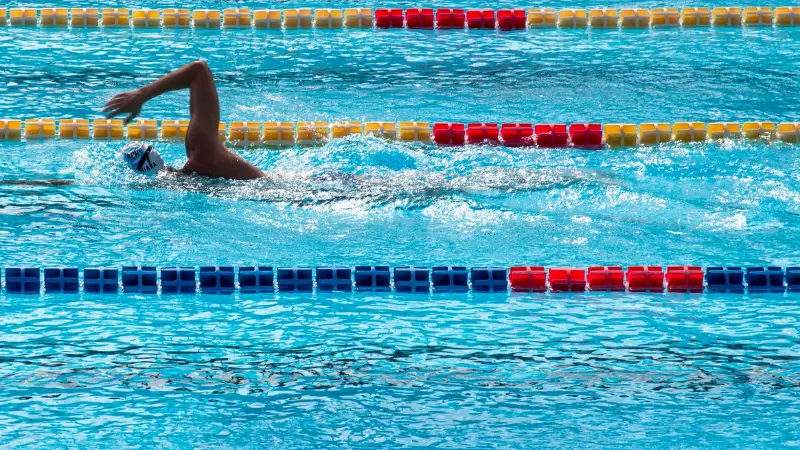 male swimmer swimming freestyle in pool